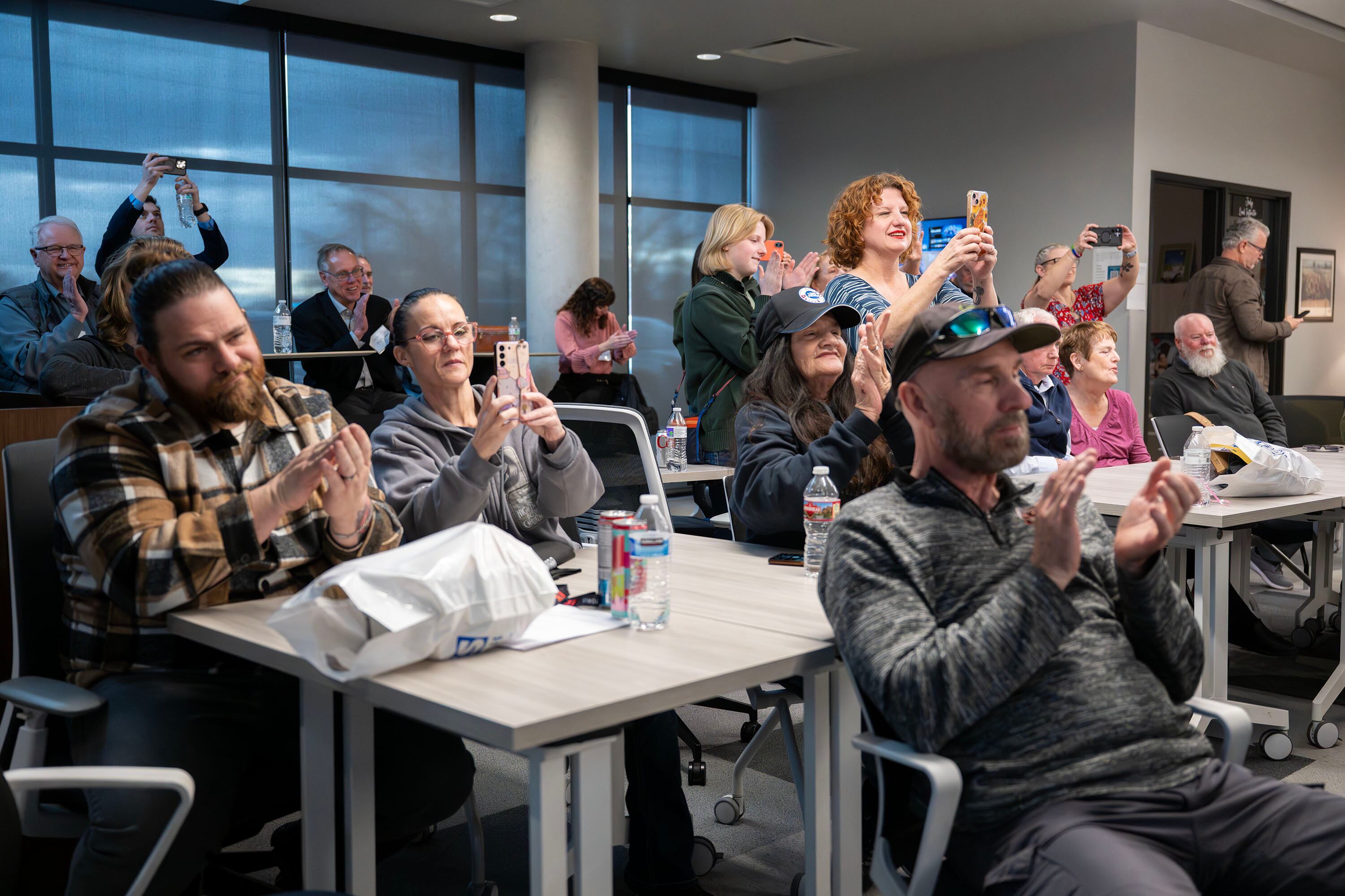 Family members of the graduates applaud and take photos during the inaugural graduation exercises of a SLCC-sponsored vocational training program for adults with autism at Nextwork Autism Program in South Salt Lake City, on Friday. The program aims to connect graduates to companies seeking their unique skill sets.