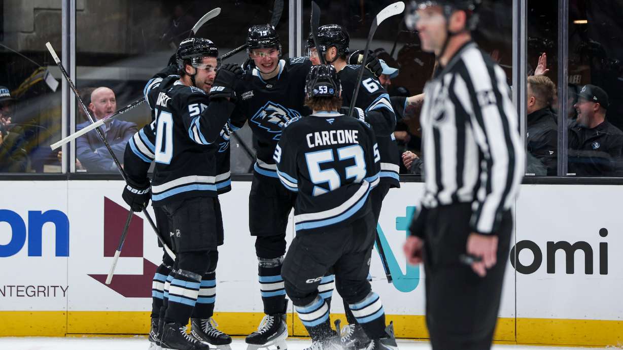 Utah Mammoth left wing Daniil But (19) celebrates with his teammates after scoring his first NHL goal during the first period of an NHL game against the New Jersey Devils at the Delta Center in Salt Lake City on Friday, Dec. 19, 2025.