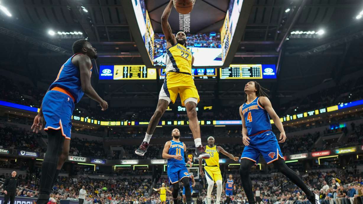 Indiana Pacers forward Isaiah Jackson (22) dunks in front of New York Knicks forward Pacome Dadiet (4) during the first half of an NBA basketball game in Indianapolis, Thursday, Dec. 18, 2025.