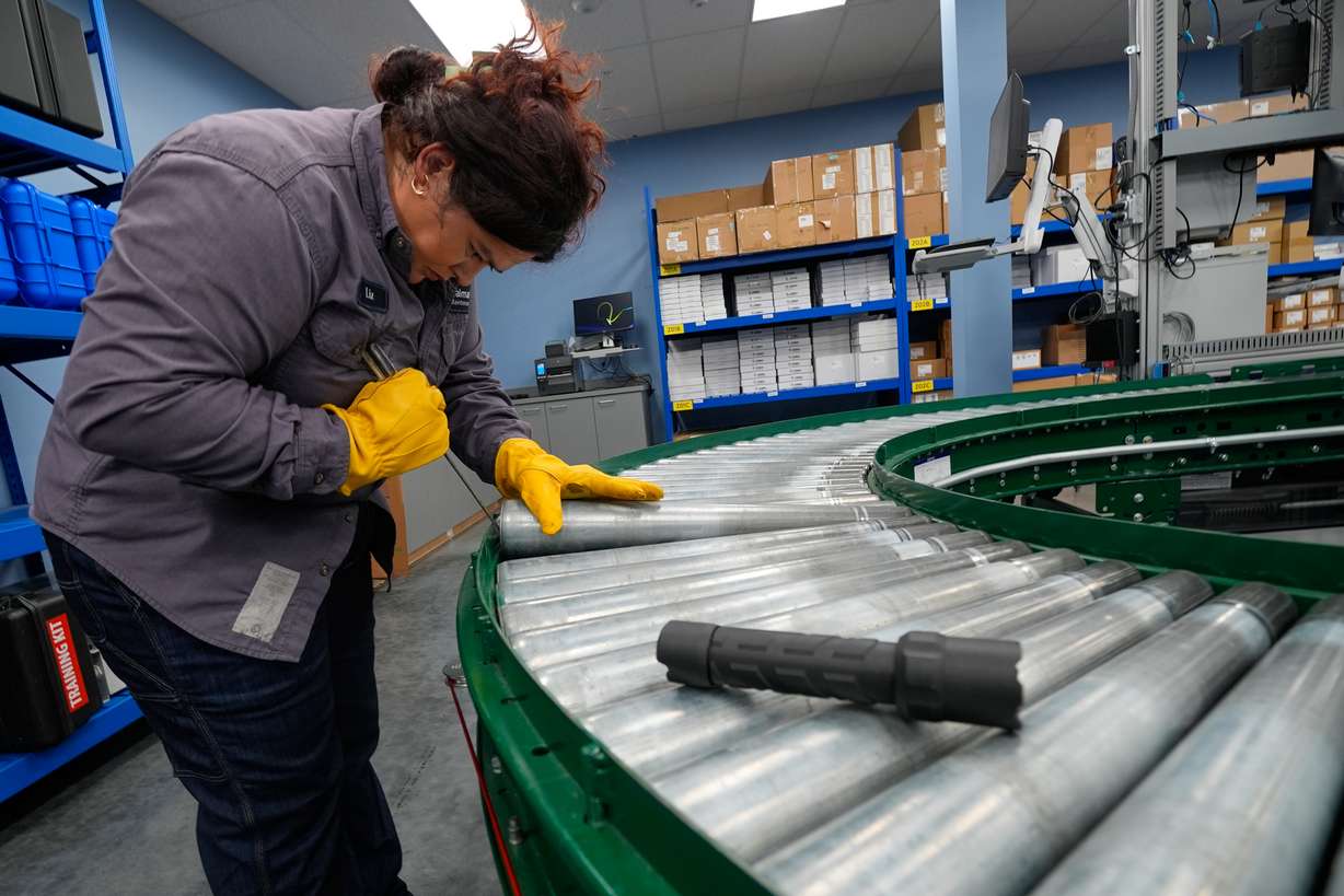 Maintenance technician Liz Cardenas replaces a conveyor belt roller at a training area in a Walmart distribution center Sept. 25, in Bentonville, Ark.