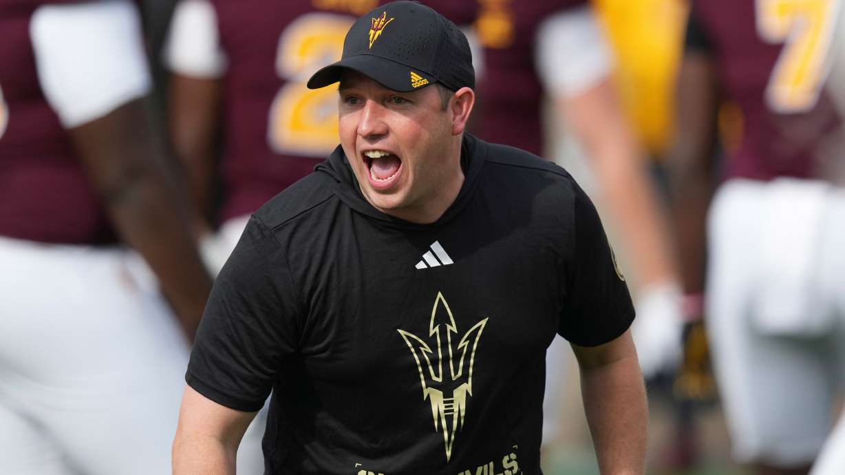 FILE - Arizona State head coach Kenny Dillingham encourages his players prior to an NCAA college football game against West Virginia Saturday, Nov. 15, 2025, in Tempe, Ariz.