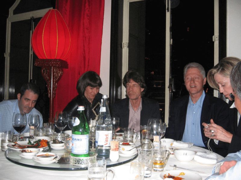 Former President Bill Clinton, Mick Jagger and Ghislaine Maxwell are seen in this image released by the Department of Justice in Washington, Friday. One of Jeffrey Epstein's victims called the heavy redactions and deletion of files a "slap in the face."