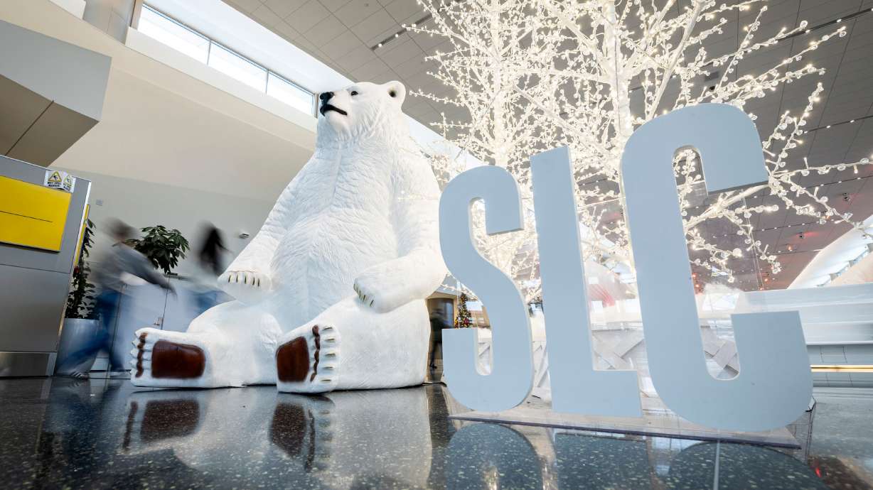 Holiday decorations are displayed as travelers walk through the Salt Lake City International Airport in Salt Lake City on Nov. 12. The airport has plenty of advice for holiday travel this year.