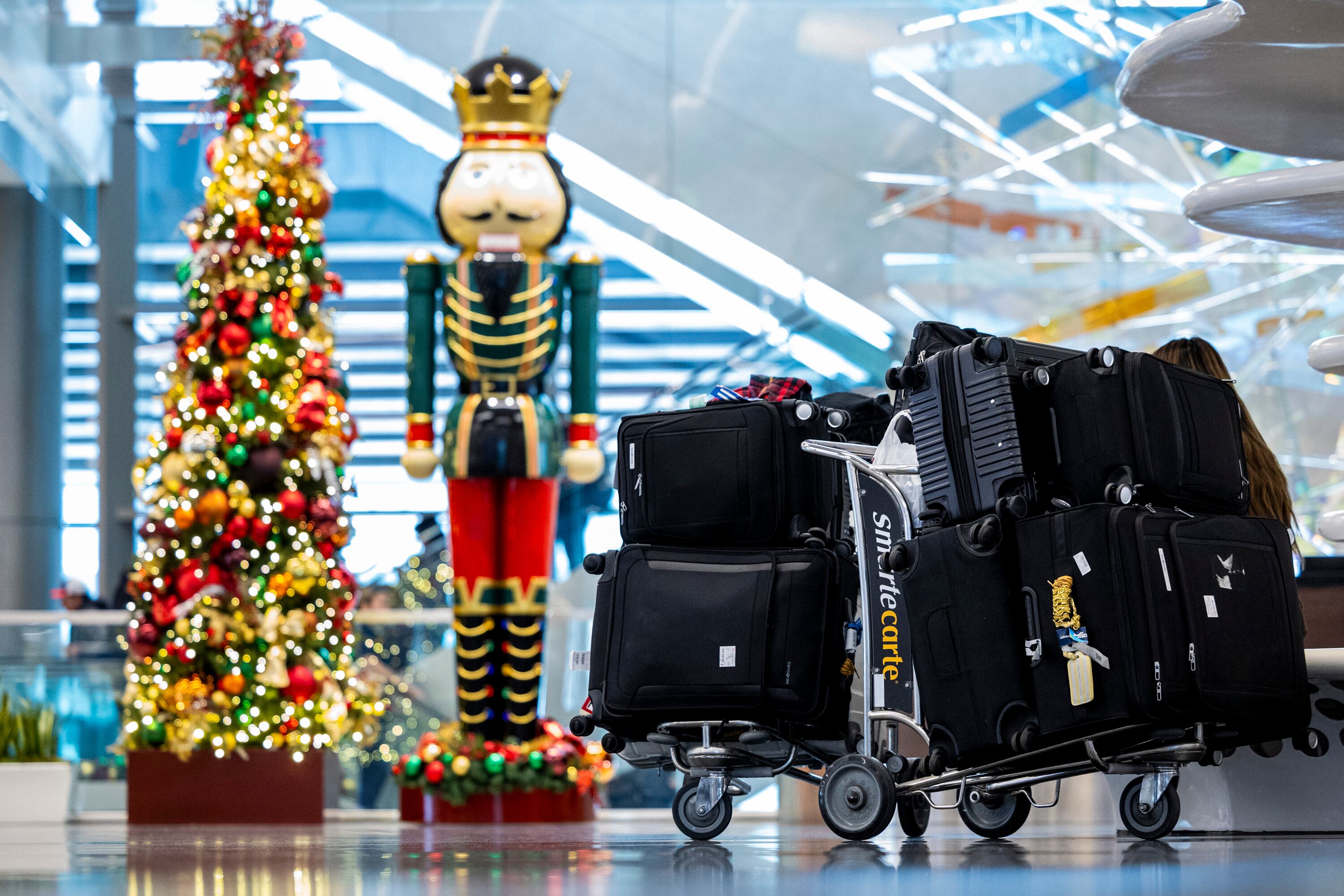 Bags are gathered by holiday decorations at the Salt Lake City International Airport on Nov. 12. The airport ranked No. 1 in on-time departures during the holidays in 2024.