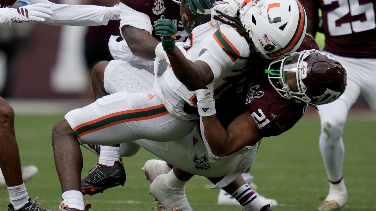 Miami wide receiver Malachi Toney (10) is tackled after a short run by Texas A&M linebacker Taurean York (21) during the first quarter in the first round of the NCAA College Football Playoff, Saturday, Dec. 20, 2025, in College Station, Texas.