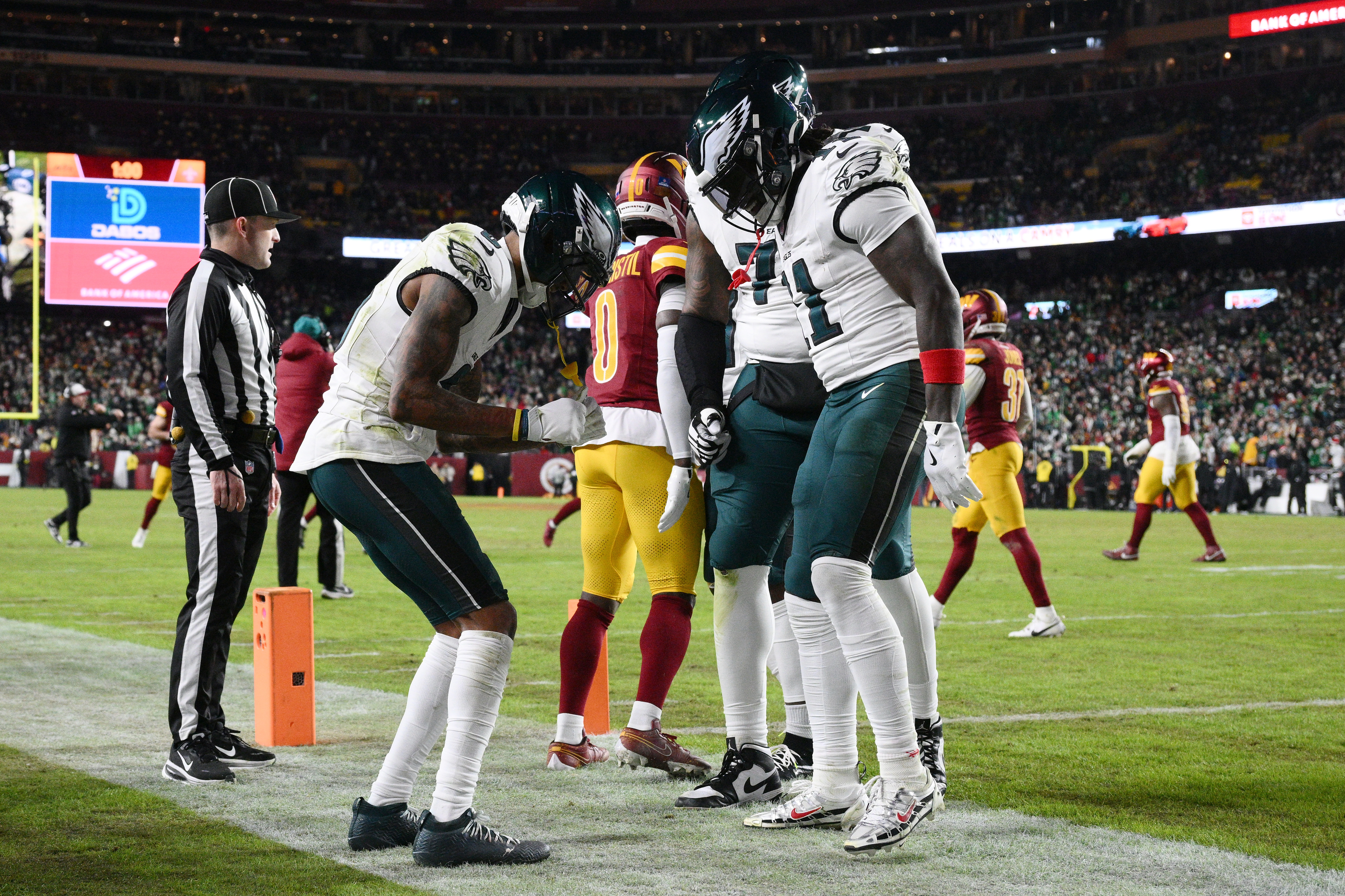 Philadelphia Eagles wide receiver Devonta Smith, front left, celebrates with teammates after his touchdown against the Washington Commanders during the first half of an NFL football game, Thursday, Dec. 20, 2025, in Landover, Md.