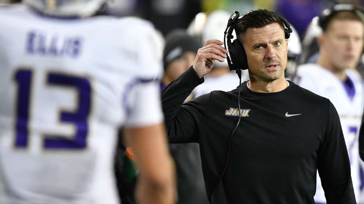 James Madison head coach Bob Chesney talks to wide receiver Landon Ellis (13) after a pass play against Oregon during the first half in the first round of the NCAA College Football Playoff, Saturday, Dec. 20, 2025, in Eugene, Ore.