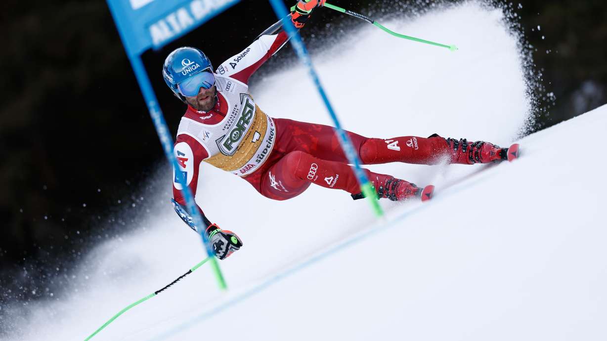 Austria's Marco Schwarz speeds down the course during an alpine ski, men's World Cup giant slalom, in Alta Badia, Italy, Sunday, Dec. 21,2025.