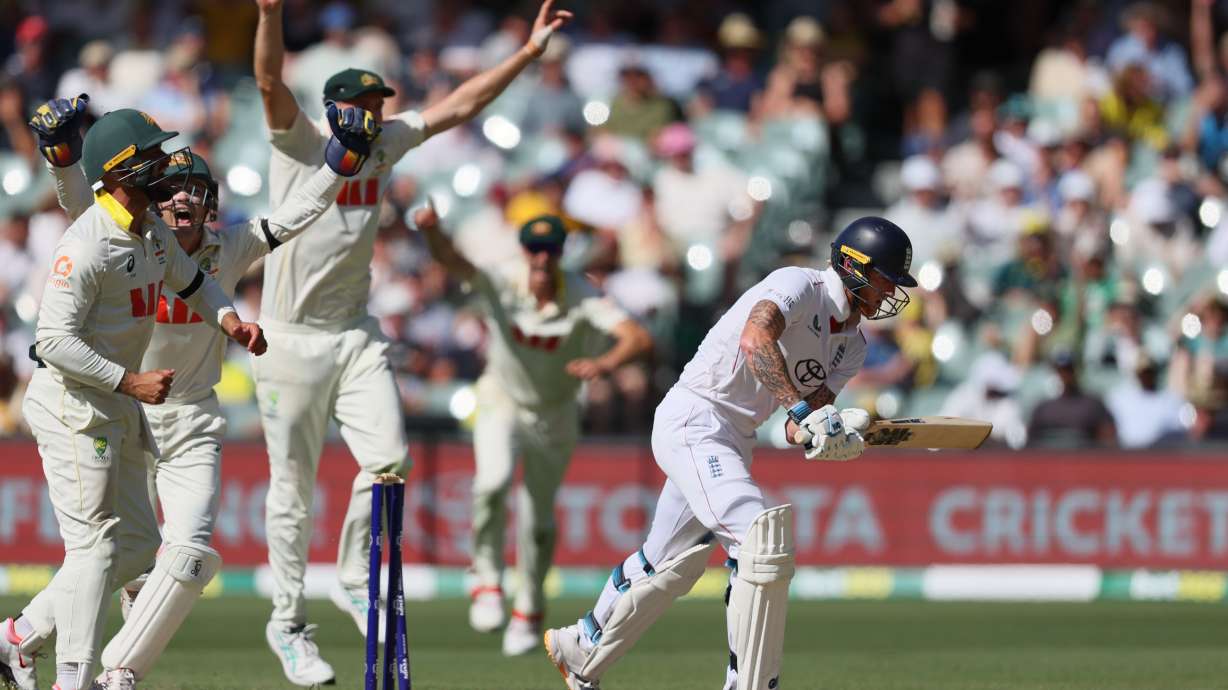Australian players celebrate after England's Ben Stokes, right, was dismissed during play on day four of the third Ashes cricket test between England and Australia in Adelaide, Australia, Saturday, Dec. 20, 2025.