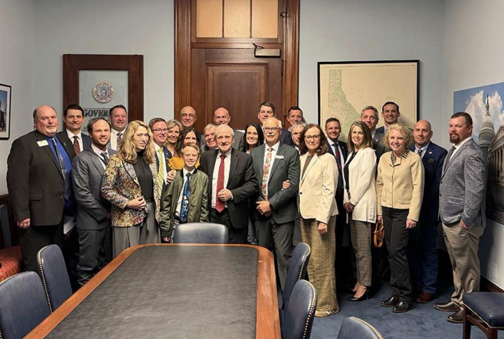 Legislators and farmers, including Josh Foster, and his wife, Georgia, left, pose for a photo inside U.S. Senator Jim Risch’s office in Washinton, D.C.