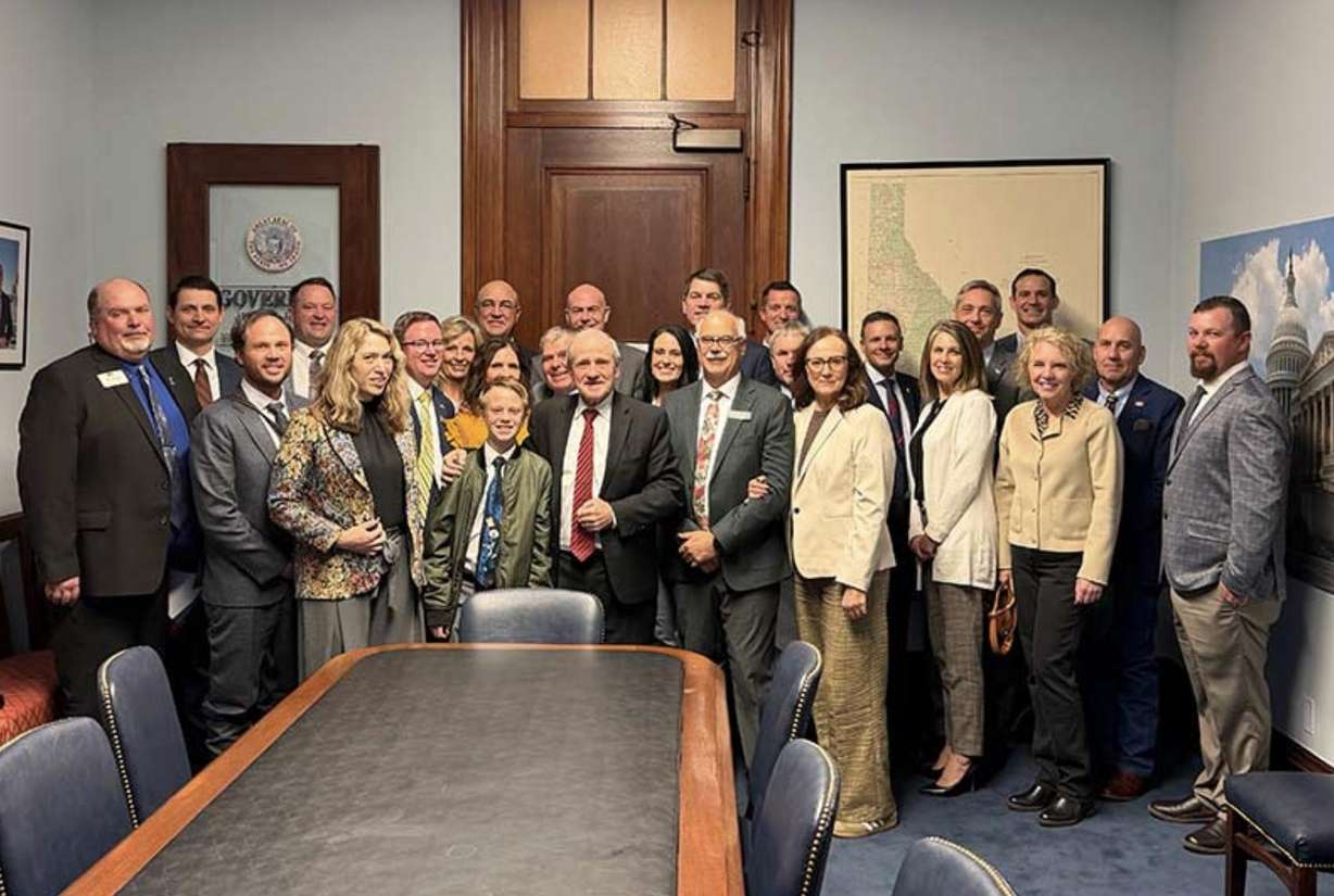 Legislators and farmers, including Josh Foster, and his wife, Georgia, left, pose for a photo inside U.S. Senator Jim Risch’s office in Washinton, D.C.