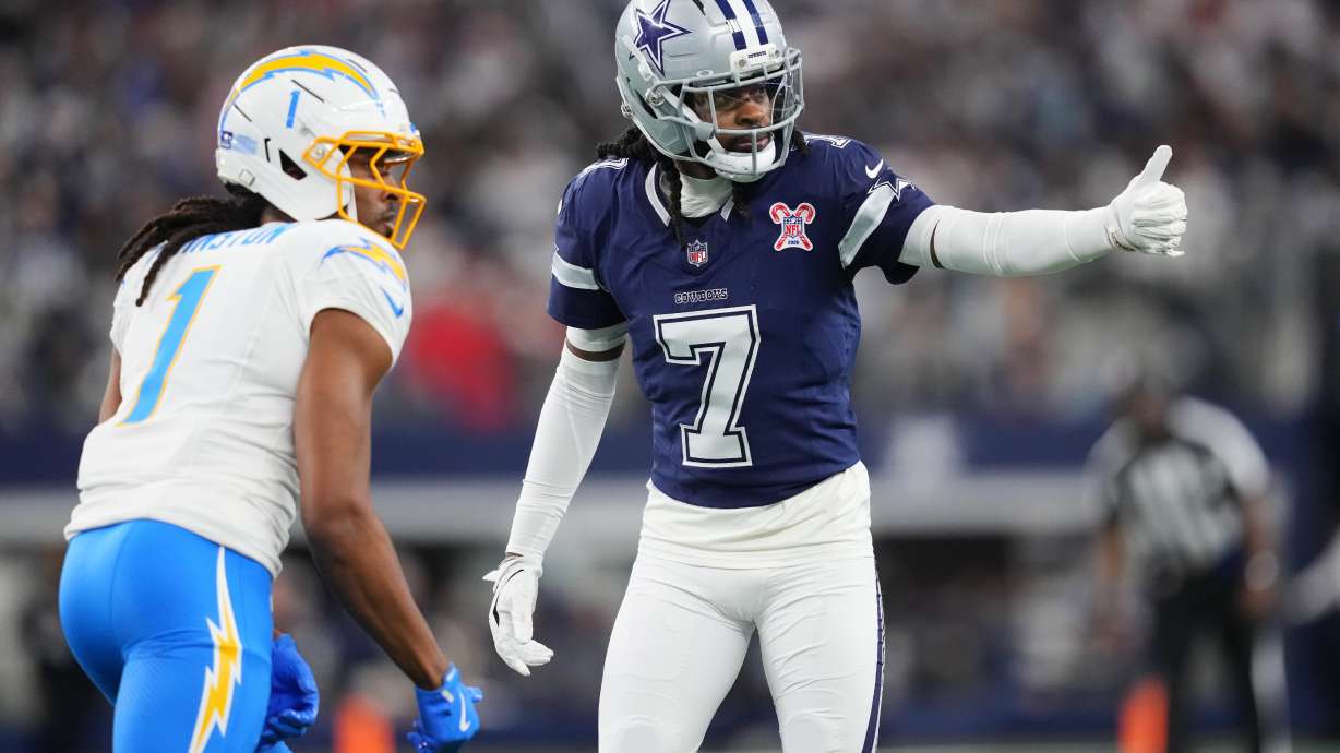 Dallas Cowboys cornerback Trevon Diggs (7) defends on Los Angeles Chargers wide receiver Quentin Johnston (1) during the first half of an NFL football game Sunday, Dec. 21, 2025, in Arlington, Texas.