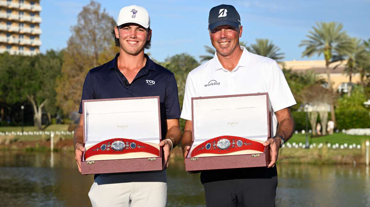 Matt Kuchar, right, and his son Cameron Kuchar hold the championship belts after winning the PNC Championship golf tournament, Sunday, Dec. 21, 2025, in Orlando, Fla.