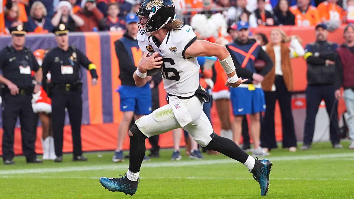 Jacksonville Jaguars quarterback Trevor Lawrence runs for a touchdown against the Denver Broncos during the second half of an NFL football game in Denver, Sunday, Dec. 21, 2025.
