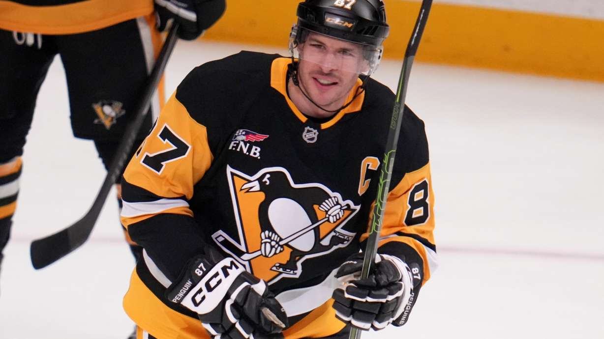 Pittsburgh Penguins' Sidney Crosby skates to his bench after scoring a goal that tied him with former Penguins player Mario Lemieux for the team's all-time points leader, during the first period of an NHL hockey game against the Montréal Canadiens in Pittsburgh, Sunday, Dec. 21, 2025.