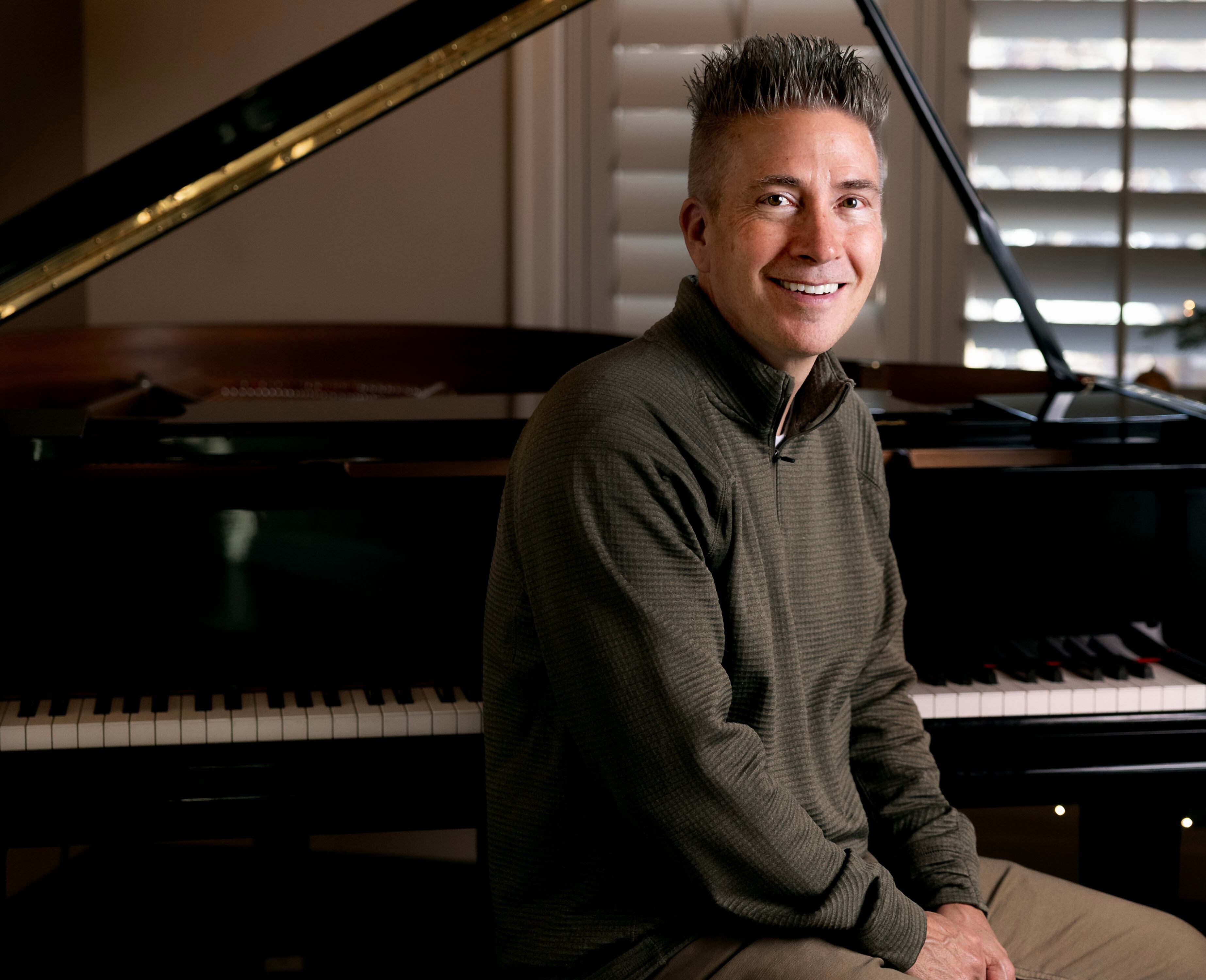 Billboard-charting composer and pianist David Tolk is photographed at his home in Draper on Dec. 10.