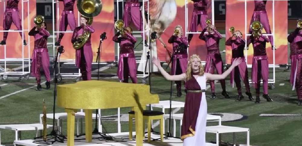 Musician surprises Herriman High School marching band while on tour