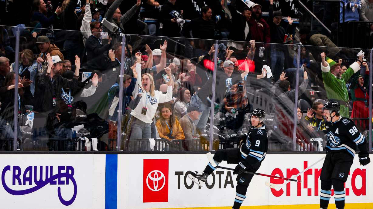 Fans cheer as Utah Mammoth right wing Clayton Keller (9) celebrates with defenseman Mikhail Sergachev (98) after scoring to beat the Winnipeg Jets 4-3 during overtime of an NHL game at the Delta Center in Salt Lake City on Sunday, Dec. 21, 2025.