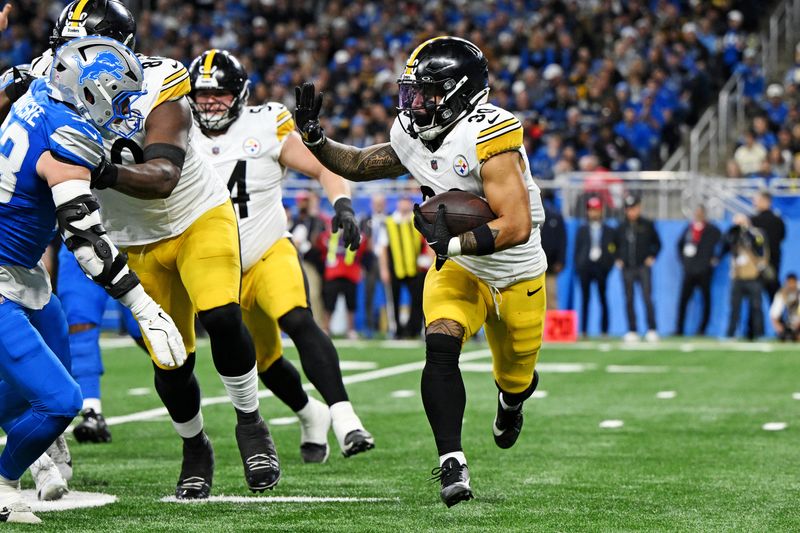 Dec 21, 2025; Detroit, Michigan, USA; Pittsburgh Steelers running back Jaylen Warren (30) runs the ball during the third quarter against the Detroit Lions at Ford Field.