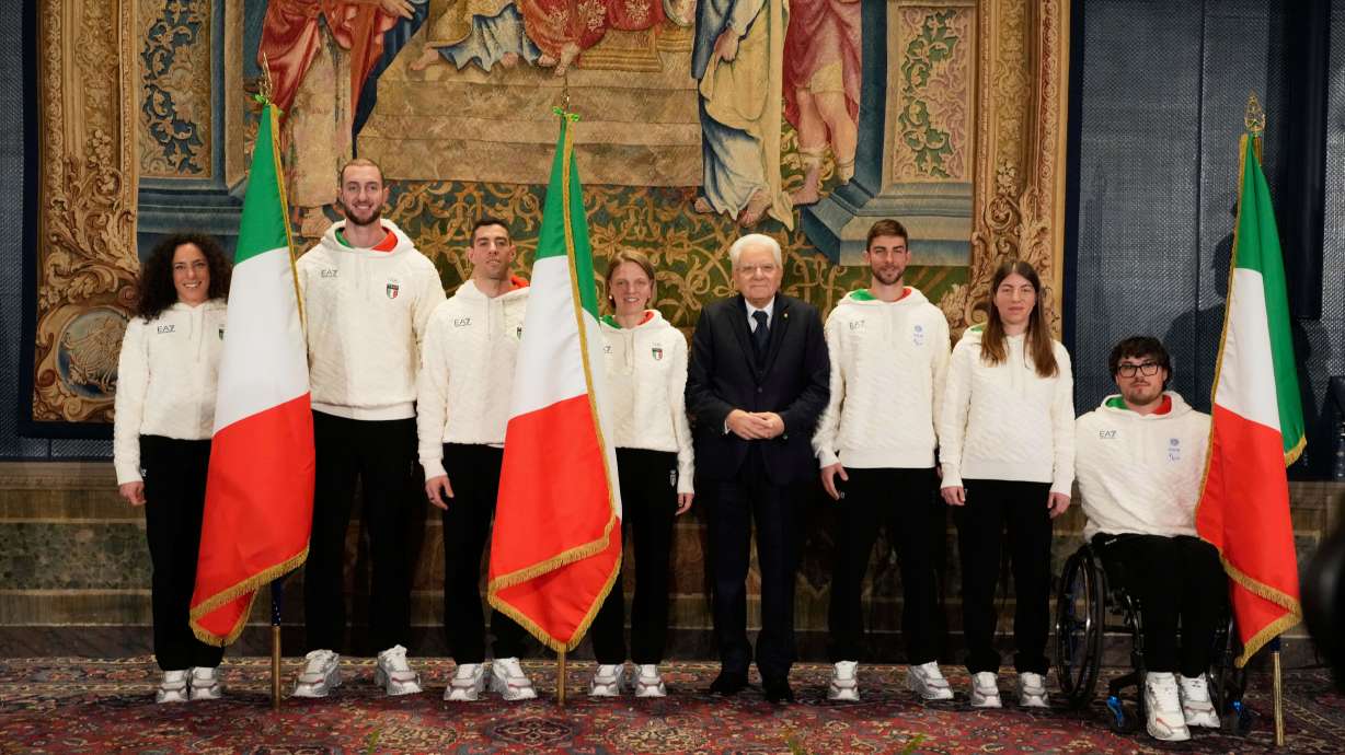 From left, Italian athletes Federica Brignone, Amos Mosaner, Federico Pellegrino, Arianna Fontana, Italian President Sergio Mattarella, Rene' de Silvestro, right, and Chiara Mazzel, second from right, pose for a group photo, during the hand over ceremony of the Italian flag for the Milan-Cortina Winter Olympic games, at the Quirinale Presidential palace, in Rome, Monday, Dec. 22, 2025.