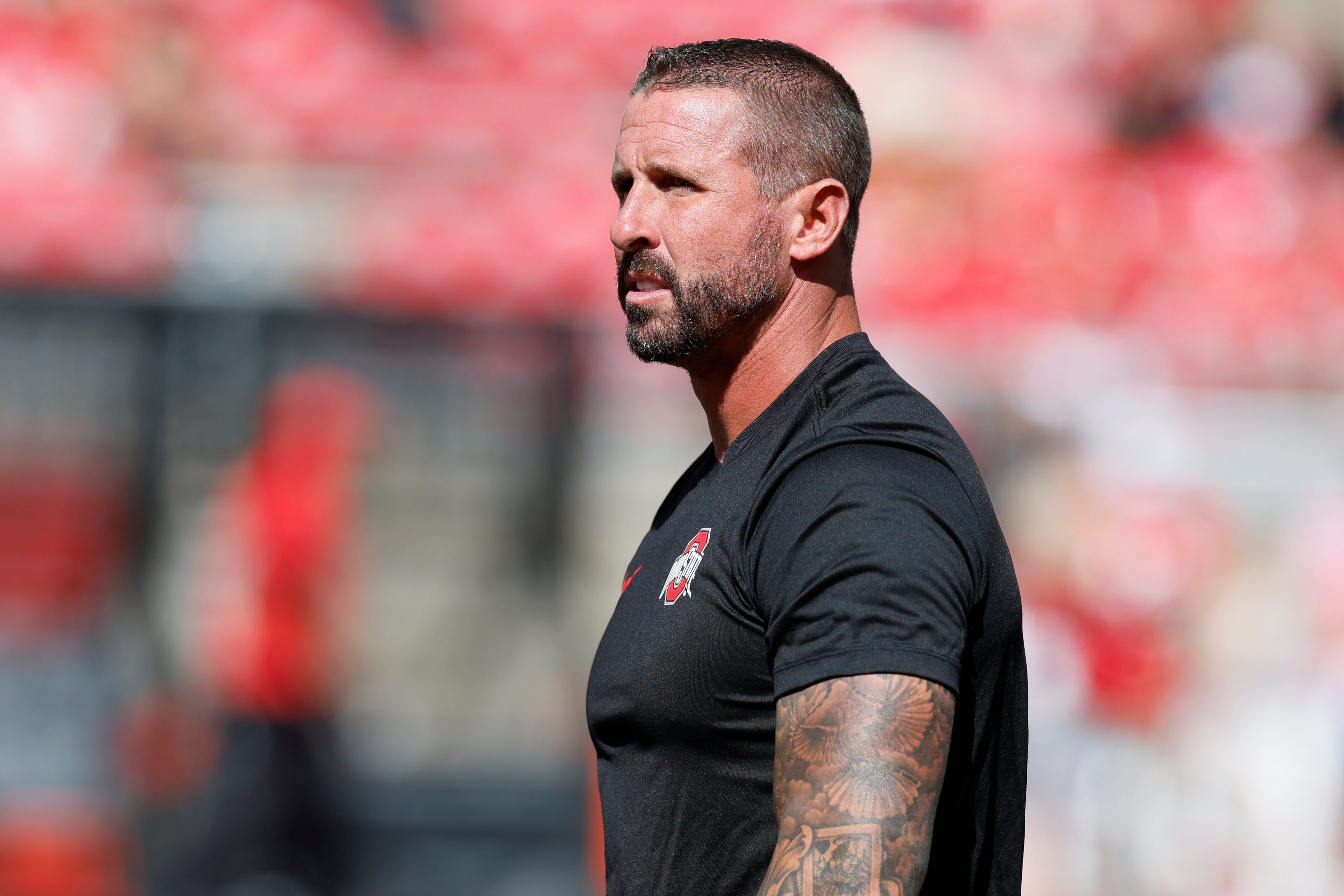 FILE - Ohio State offensive coordinator and wide receivers coach Brian Hartline stands on the field before the start of their NCAA college football game against Texas, Aug. 30, 2025, in Columbus, Ohio.