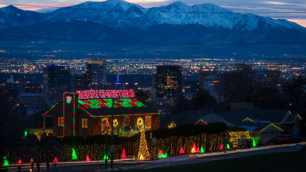 The Salt Lake skyline is visible behind Christmas lights at a home in the Avenues on Dec. 13. Utah is in to receive storms for Christmas Eve and Christmas Day, but meteorologists say that warmer conditions will keep snow lines high on the holiday.