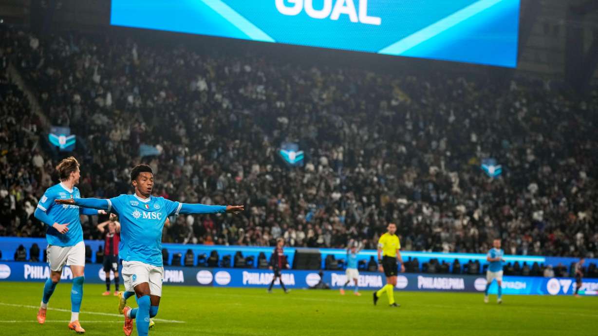 Napoli's David Neres, center, celebrates after scoring during the Italian Super Cup final soccer match between Napoli and Bologna in Riyadh, Saudi Arabia, Monday, Dec. 22, 2025.
