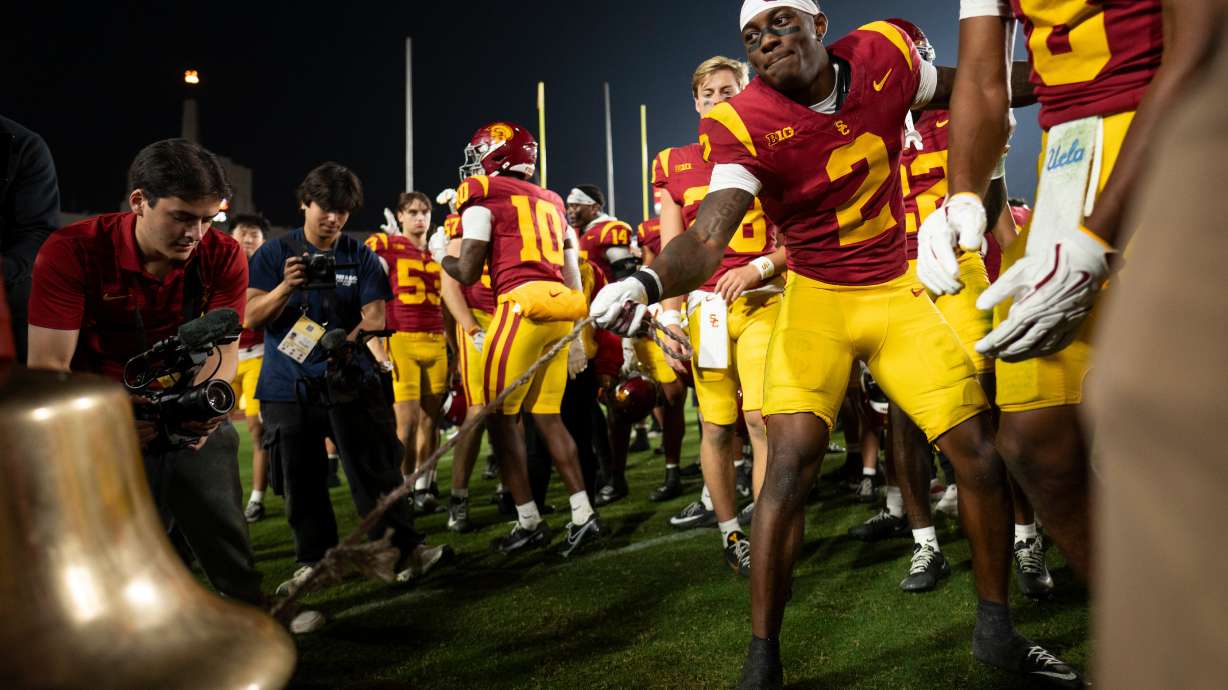 Southern California defensive back DJ Harvey (2) rings the Victory Bell after an NCAA college football game against UCLA Saturday, Nov. 29, 2025, in Los Angeles.