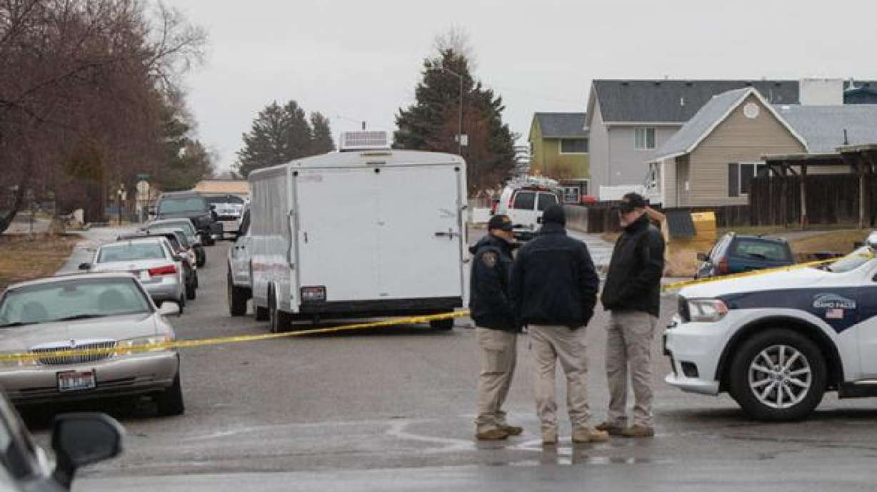 Officers talk with one another at the intersection of Cleveland Street and Wabash Avenue in Idaho Falls. A man was shot and killed by officers Monday morning after he allegedly grabbed a knife during a domestic violence investigation.