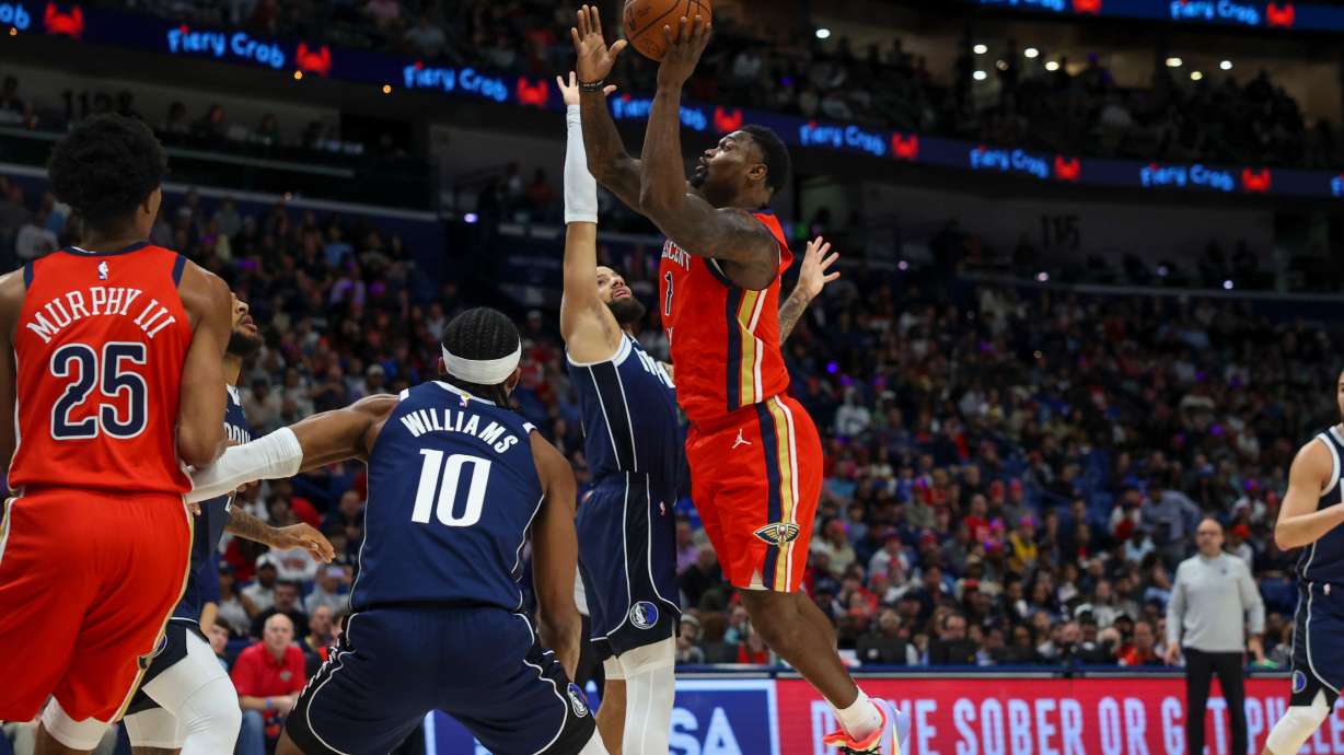 New Orleans Pelicans forward Zion Williamson (1) shoots a layup against Dallas Mavericks forward Daniel Gafford, left, in the first half of an NBA basketball game Monday, Dec. 22, 2025, in New Orleans.