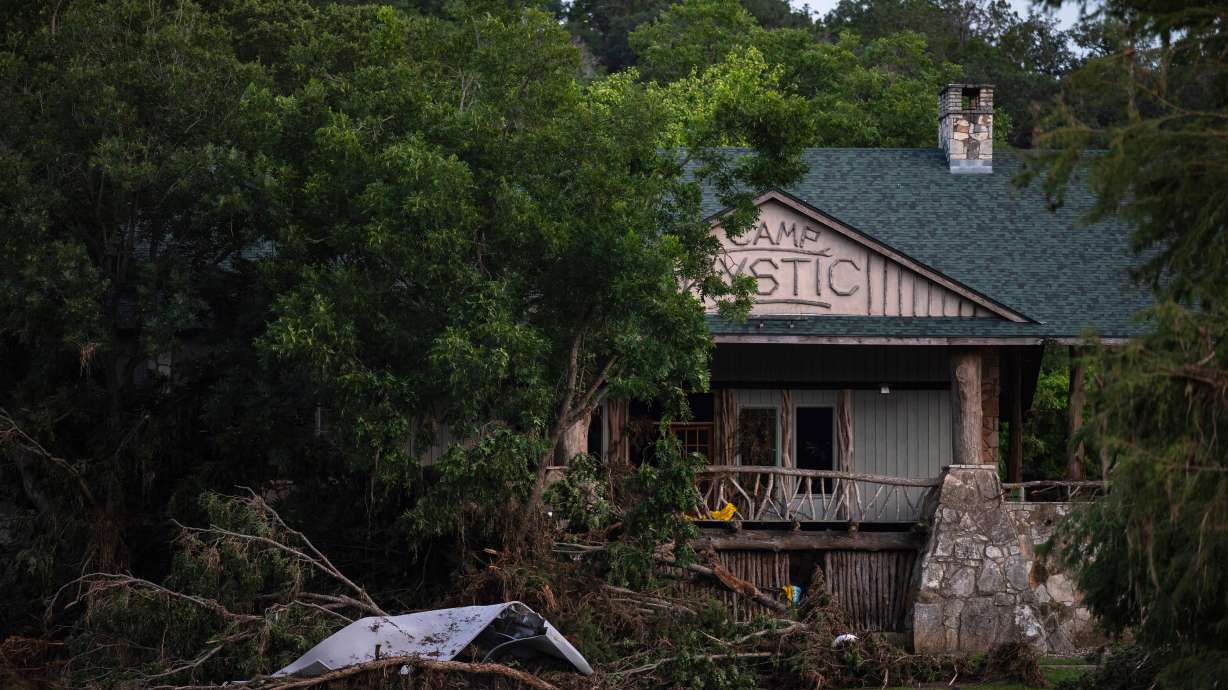 Debris covers the area of Camp Mystic in Hunt, Texas, July 7, after a devastating flash flood swept through the area. The 100-year-old camp will begin enrolling new campers in January, but the decision is dividing families who've sent their children there.