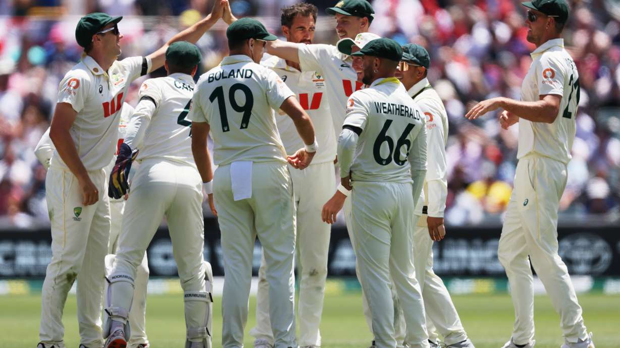 Australian players celebrate the dismissal of England's Jamie Smith during play on the final day of the third Ashes cricket test between England and Australia in Adelaide, Australia, Sunday, Dec. 21, 2025.