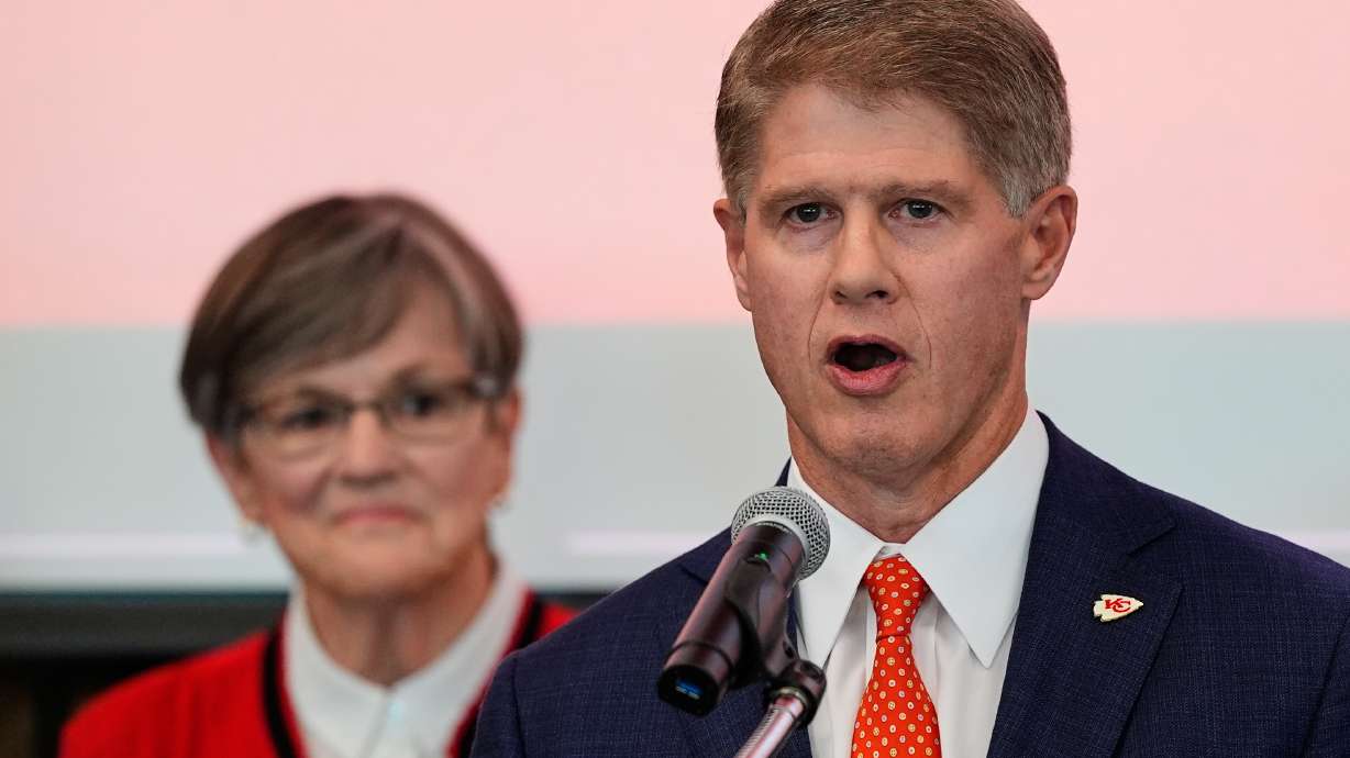 Kansas City Chiefs owner Clark Hunt, right, addresses attendees while Kansas Gov. Laura Kelly, left, looks on during an event Monday, Dec. 22, 2025, in Topeka, Kan., announcing the team will leave Arrowhead Stadium in Kansas City, Mo. for a new stadium that will be built across the Kansas-Missouri state line and be ready for the start of the 2031 season.