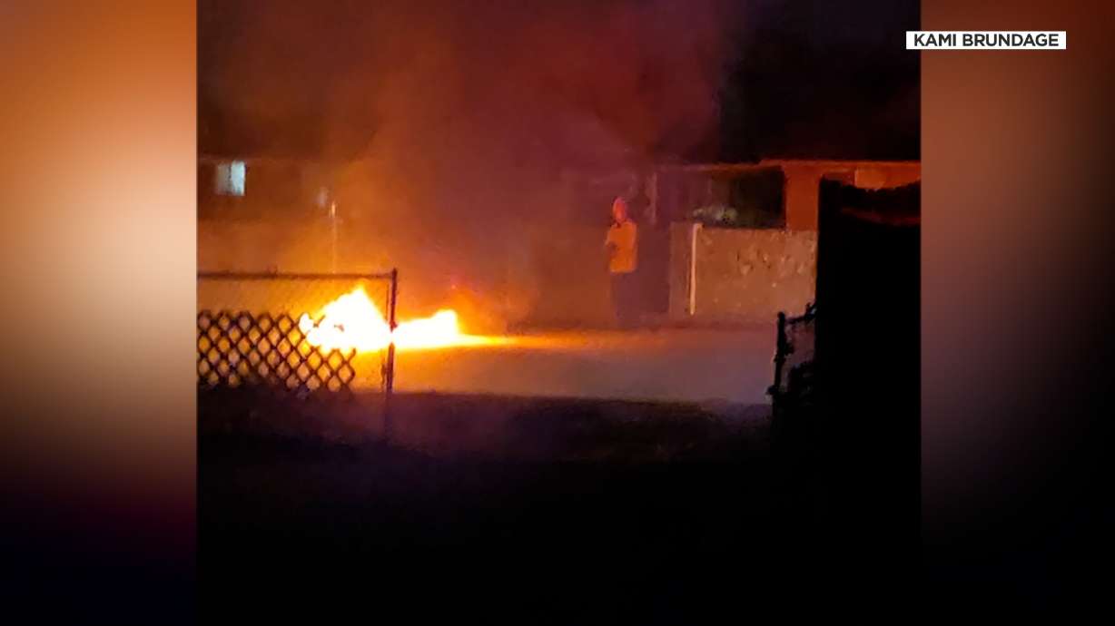 A motorcycle is seen in flames after a fatal crash in Taylorsville on Monday.