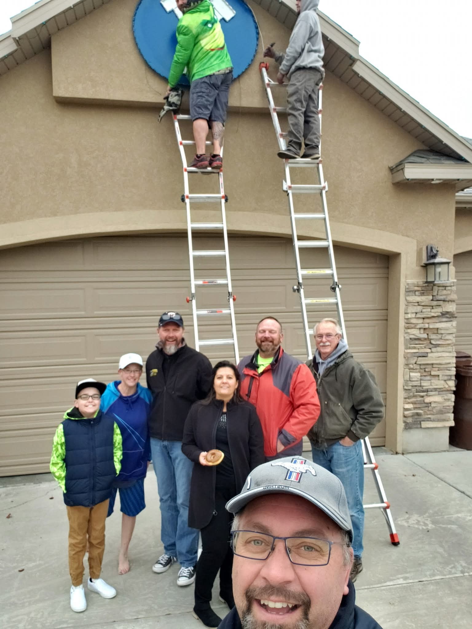 The Page family posed for a picture with Tony Emerine and his team, who hung holiday lights for Wyatt Page, who had terminal cancer. Wyatt, 12, passed away in 2020 from cancer.