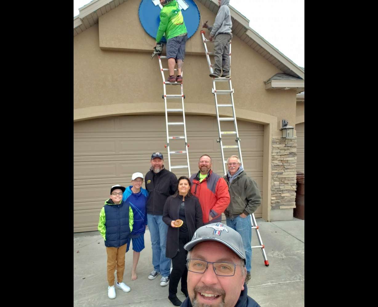 The Page family posed for a picture with Tony Emerine and his team, who hung holiday lights for Wyatt Page, who had terminal cancer. Wyatt, 12, passed away in 2020 from cancer.