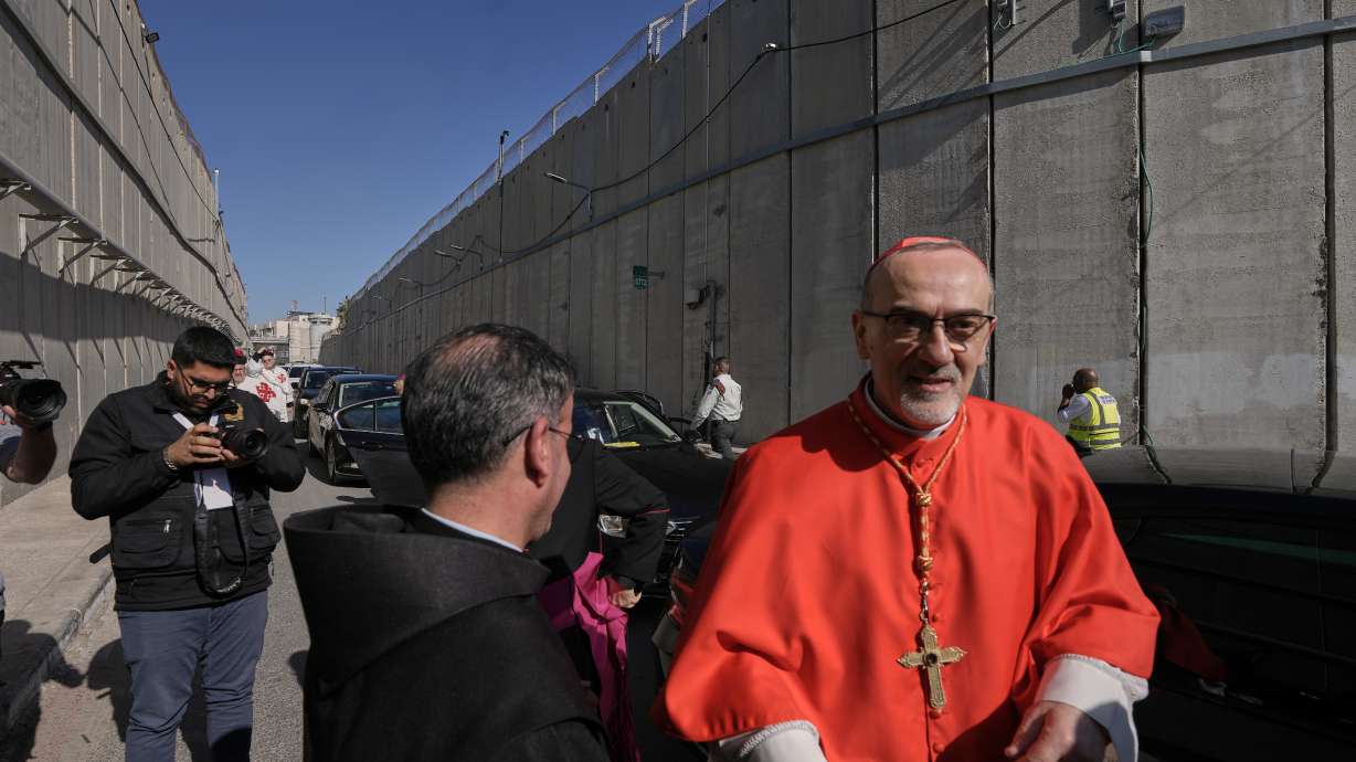 Latin Patriarch Pierbattista Pizzaballa, the top Catholic clergyman in the Holy Land, crosses an Israeli military checkpoint from Jerusalem to Bethlehem ahead of Christmas Eve celebrations at the Church of the Nativity on Wednesday.