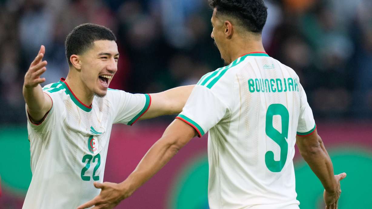 Algeria's Ibrahim Maza, left, celebrates with Algeria's Baghdad Bounedjah after scoring his side's third goal during the Africa Cup of Nations group E soccer match between Algeria and Sudan in Rabat, Morocco, Wednesday, Dec. 24, 2025.
