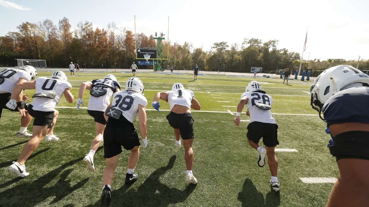 BYU running back Jovesa Damuni (28) warms up with teammates during practice before the Pop-Tarts Bowl, Tuesday, Dec. 23, 2025 in Orlando, Florida.