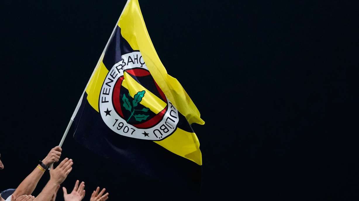 FILE - Fenerbahce fans celebrate the win of their team during the Europa League group B soccer match between AEK and Fenerbahce at AEK arena stadium in Larnaca, Cyprus, Oct. 13, 2022.