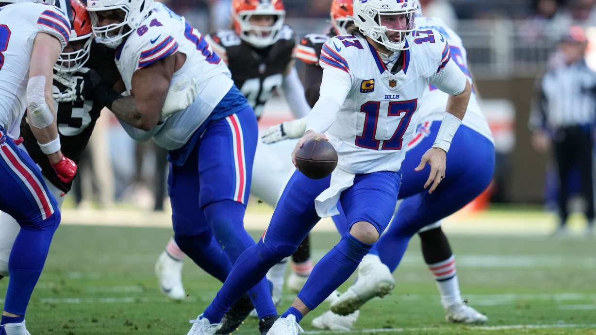 Buffalo Bills quarterback Josh Allen (17) hands off against the Buffalo Bills during the second half of an NFL football game in Cleveland, Sunday, Dec. 21, 2025.