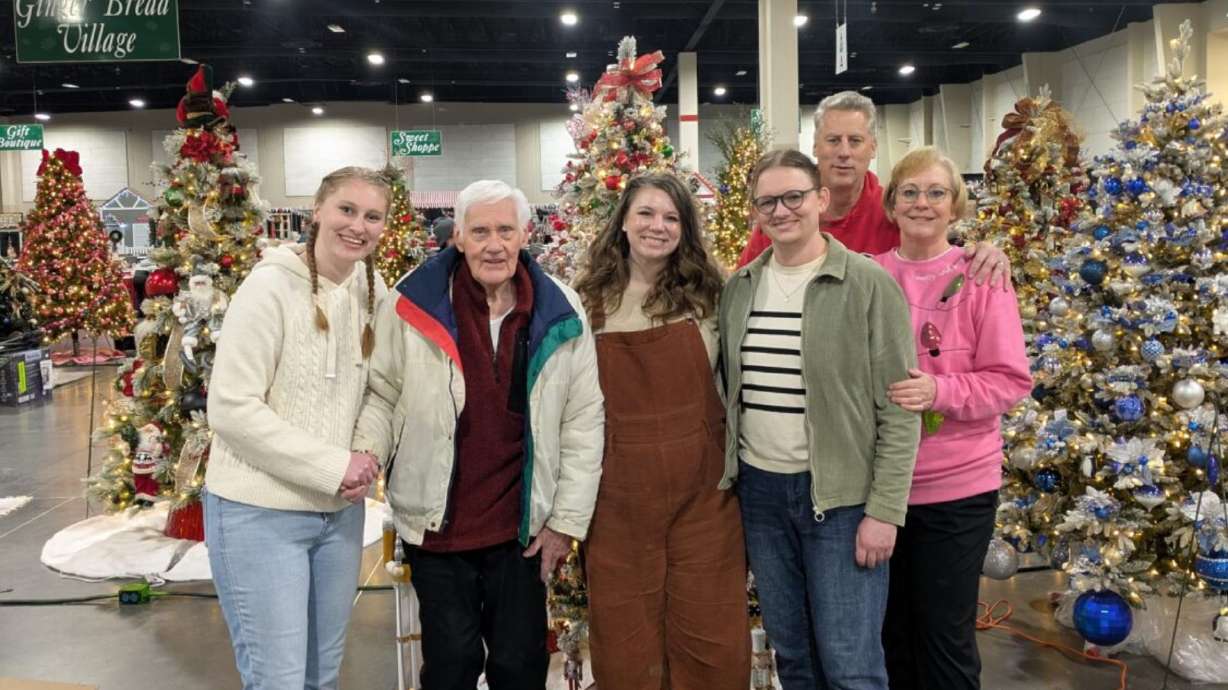 Lowell Baum, second from left, stands with his son and extended family at this year's Festival of Trees. Baum has crafted elaborate 9-foot trees to donate to the annual event for decades.