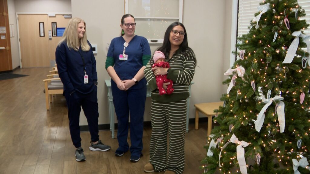 Nurses Corinna Bacon and Jessica Foutz, who helped deliver Jaxson, visit with him and Karina Largo.