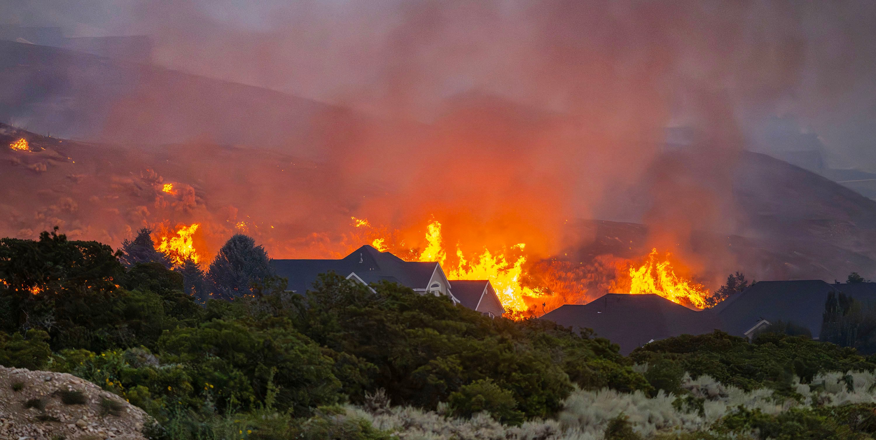 Fire burns near homes and on the mountain in North Ogden on Aug. 13.