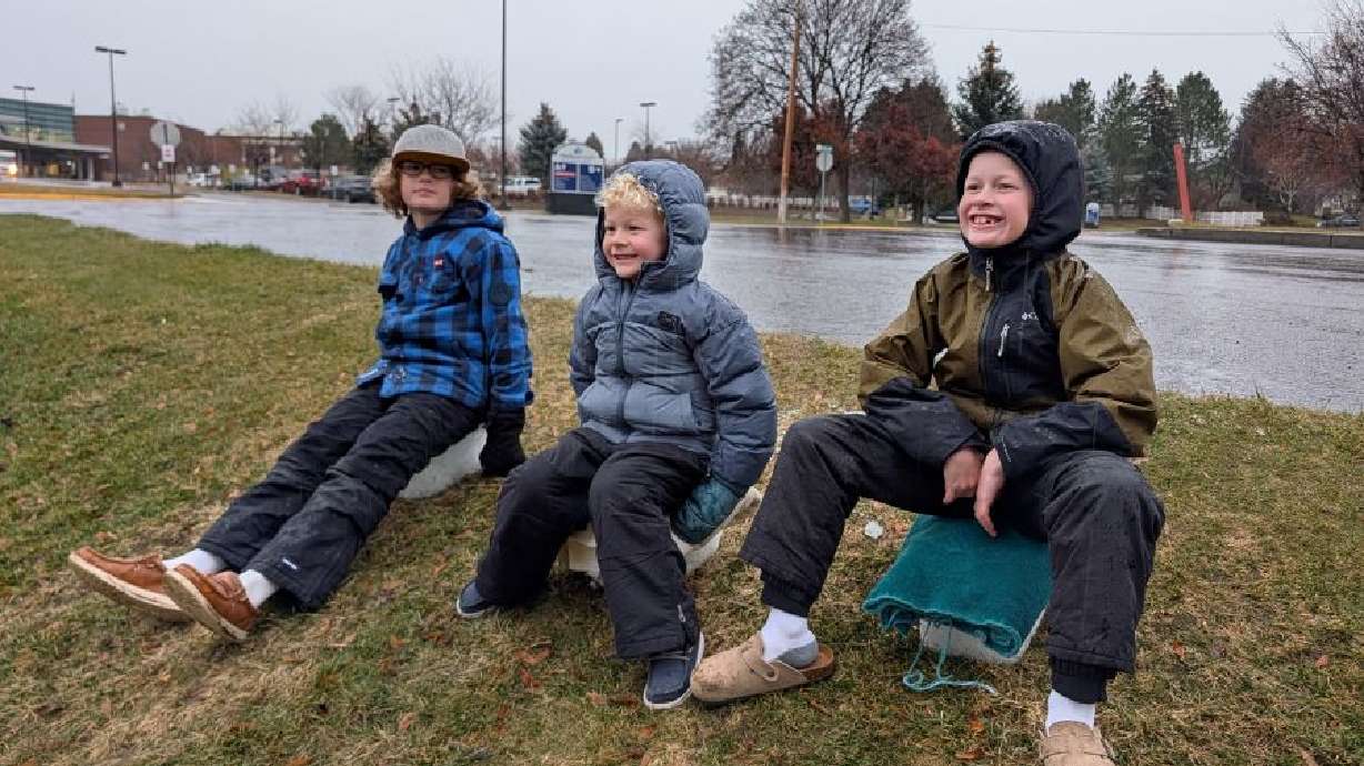 Price, Merrick and Grant Haley, of Rexburg, go ice-blocking, or ice-sledding, as a fun activity this holiday season because there wasn’t any snow.