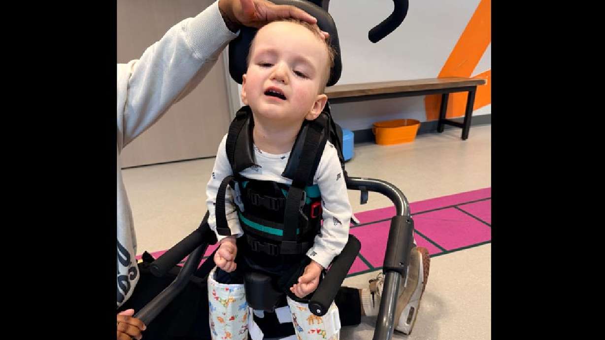 Clair Davids practices using a gait trainer during an intensive physical therapy session in Idaho Falls.