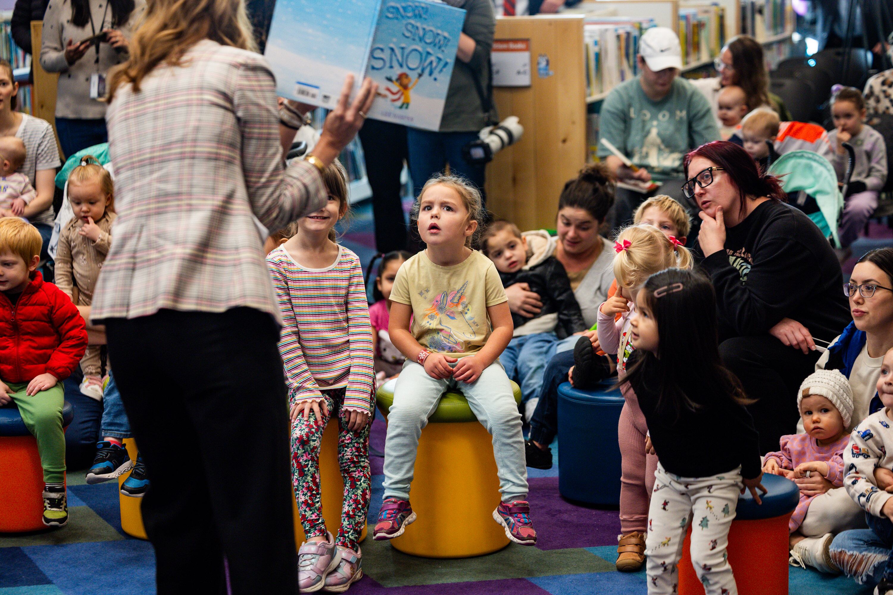 First lady Abby Cox reads to children at Kearns Library after a press conference discussing the fiscal year 2026-27 budget rollout in Kearns on Dec. 3.