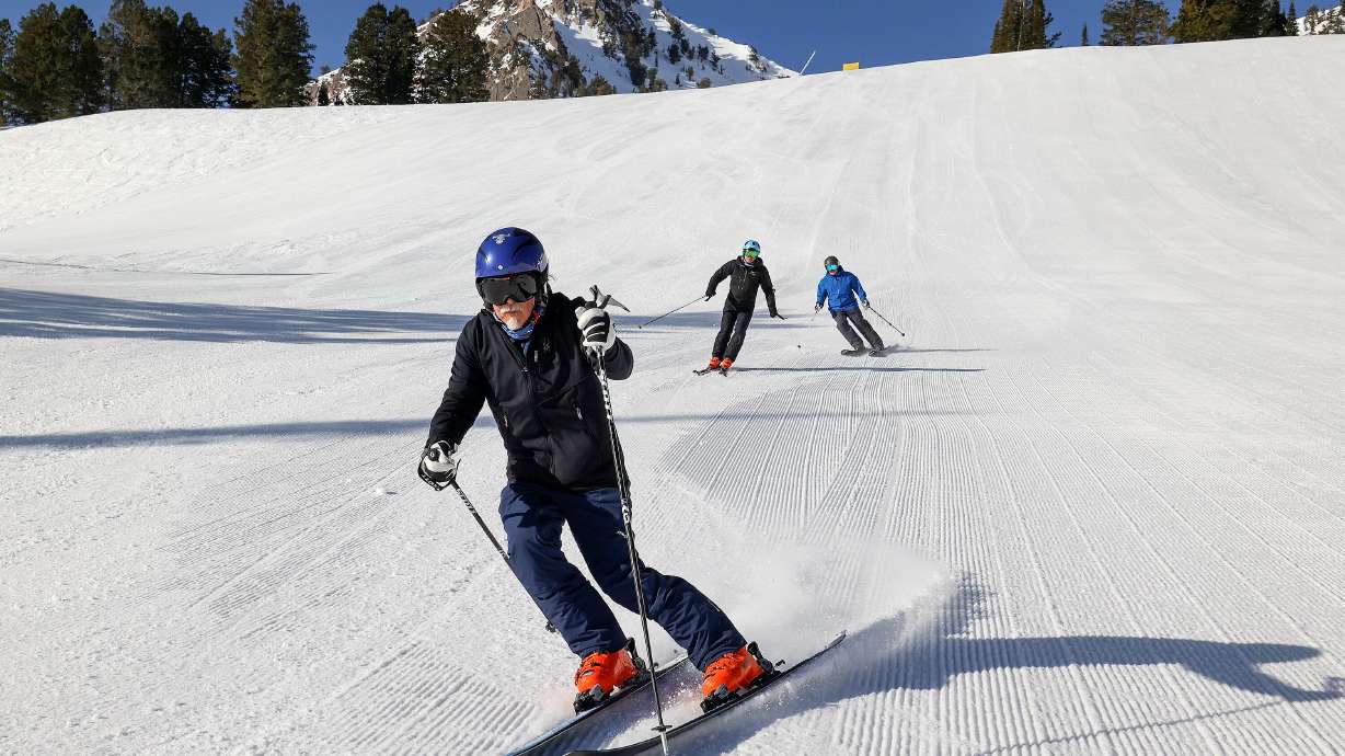 Tom Hart, known as Racer Tom, skies during a photo shoot at Snowbasin Resort in Weber County on April 10, 2025. Hart is trying to ski 10,000,000 vertical feet this season. His ski buddies Jeff Toone and Scott Harris are behind him.
