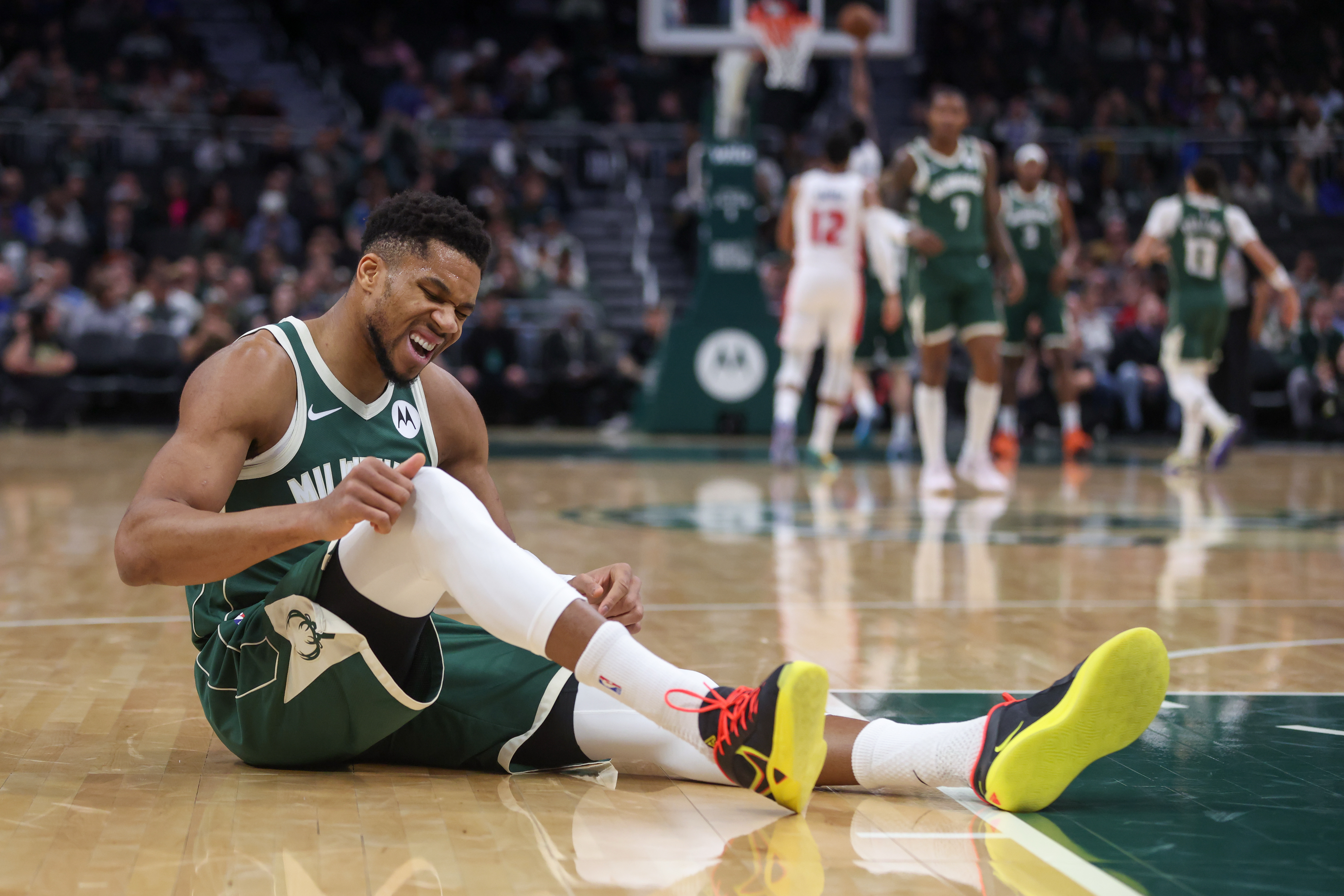 FILE - Milwaukee Bucks' Giannis Antetokounmpo reacts after suffering an injury during the first half an NBA basketball game against the Detroit Pistons, Wednesday, Dec. 3, 2025, in Milwaukee.