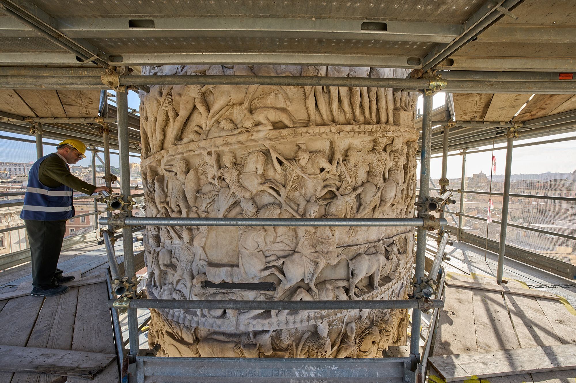 Luca Del Fra, press officer for Rome's Special Superintendency looks at bas-reliefs depicting scenes from a battle on the second-century A.D. Column of Marcus Aurelius in central Rome during a media tour, Dec. 18.